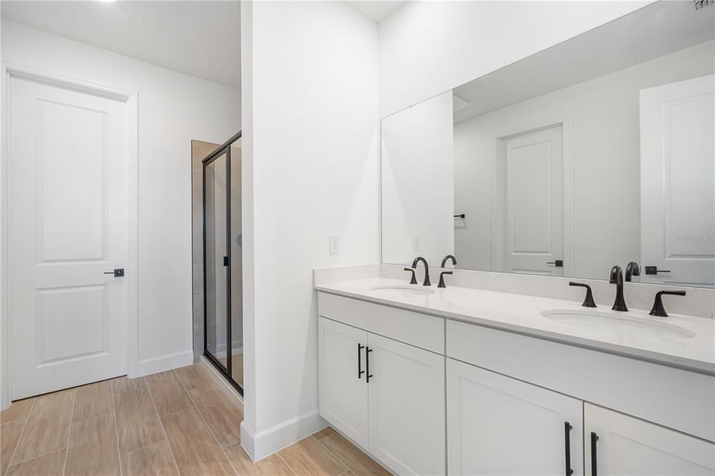 9196 Players Drive Weeki Wachee, FL 34613 - Photo 18 of 29 a bathroom with a double vanity sink and mirror