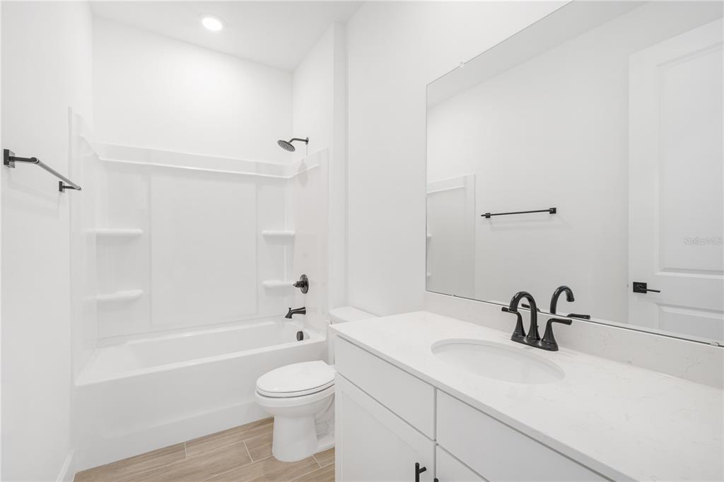 9196 Players Drive Weeki Wachee, FL 34613 - Photo 27 of 29 a bathroom with a sink a toilet and a bathtub