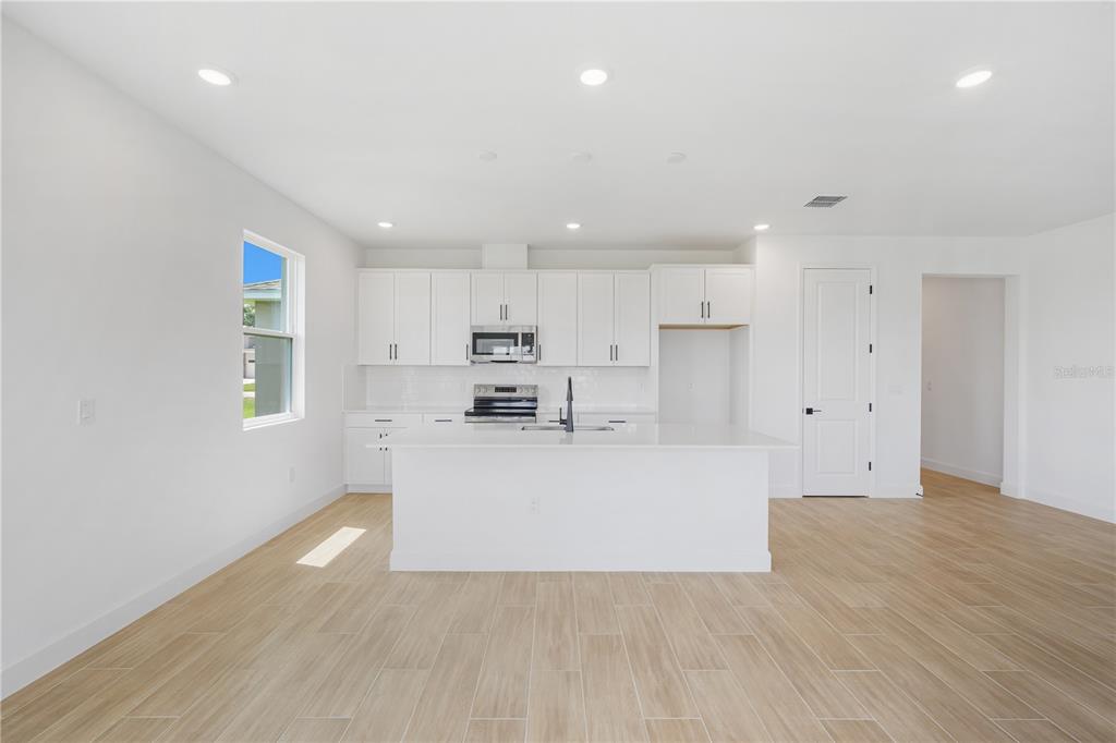 9196 Players Drive Weeki Wachee, FL 34613 - Photo 8 of 29 a view of kitchen with stainless steel appliances refrigerator oven and cabinets