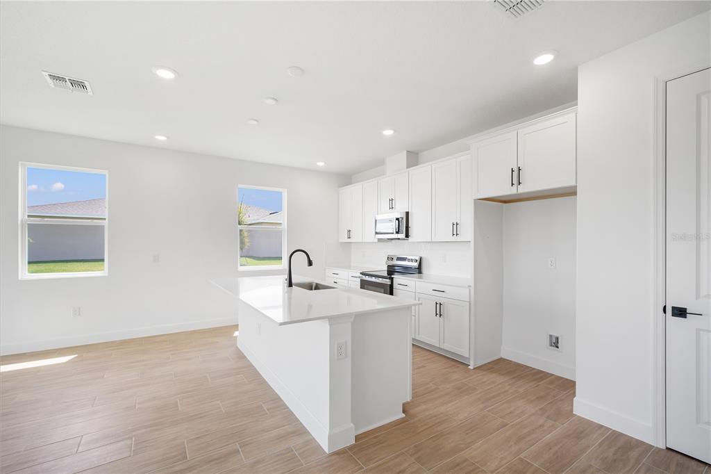 9196 Players Drive Weeki Wachee, FL 34613 - Photo 9 of 29 a kitchen with a sink cabinets and wooden floor