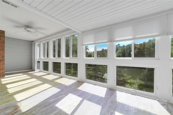 an empty room with windows and entrance