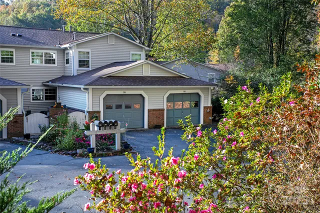 a front view of a house with a porch and garden