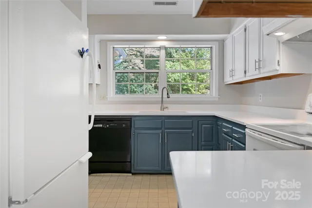 a kitchen with stainless steel appliances a refrigerator sink and cabinets