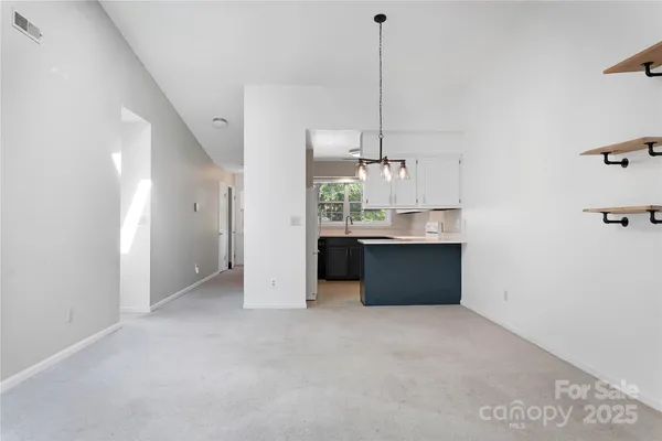 a view of a kitchen with a sink and window