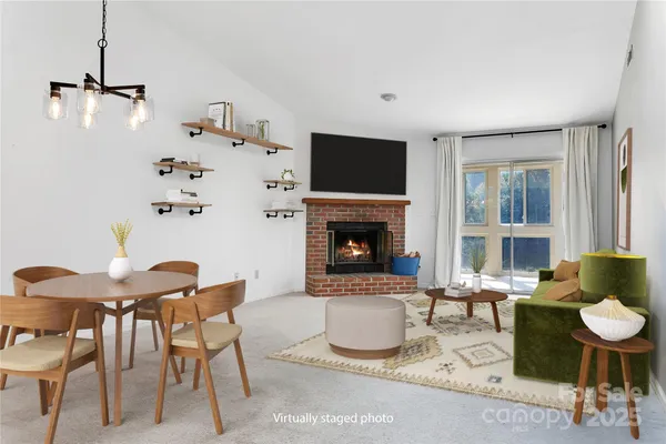 a living room with furniture a flat screen tv and a fireplace