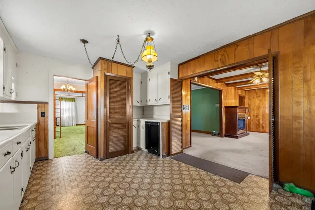 a kitchen with granite countertop a stove a sink and a refrigerator