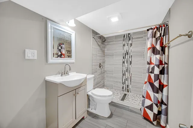 a bathroom with a sink toilet and shower