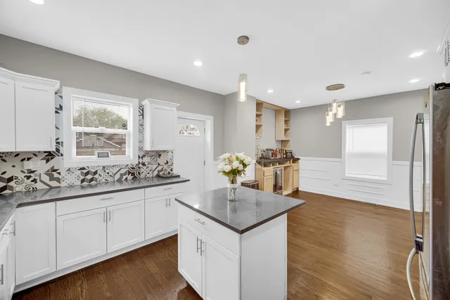 a kitchen with granite countertop a sink and cabinets