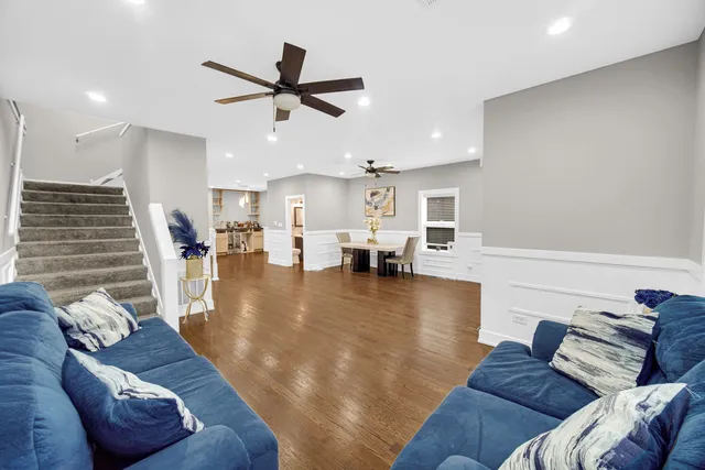 a living room with furniture and wooden floor