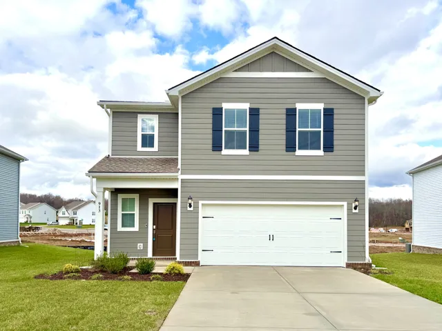 a front view of a house with a yard and garage