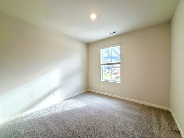 an empty room with closet and bathroom