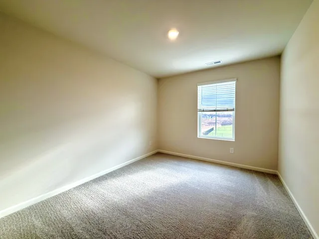 a view of an empty room and closet area