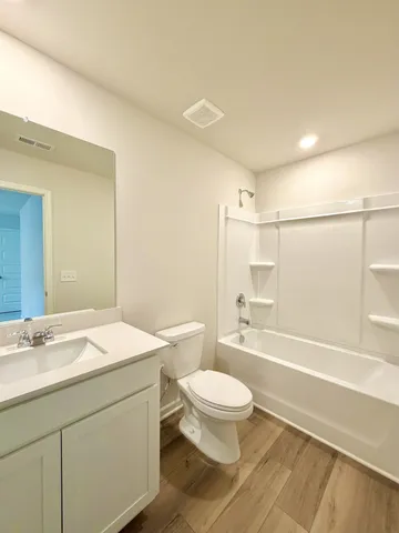 a bathroom with a shower and a bath tub
