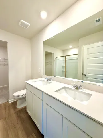 a bathroom with a glass shower door