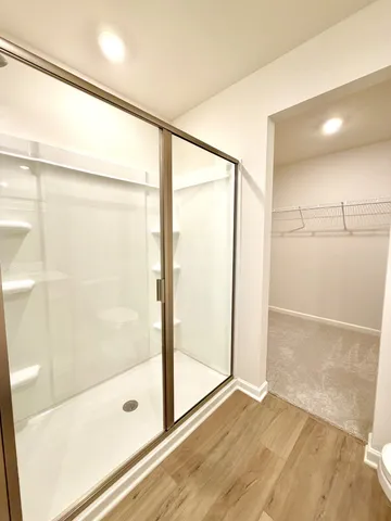 a bathroom with a glass shower door