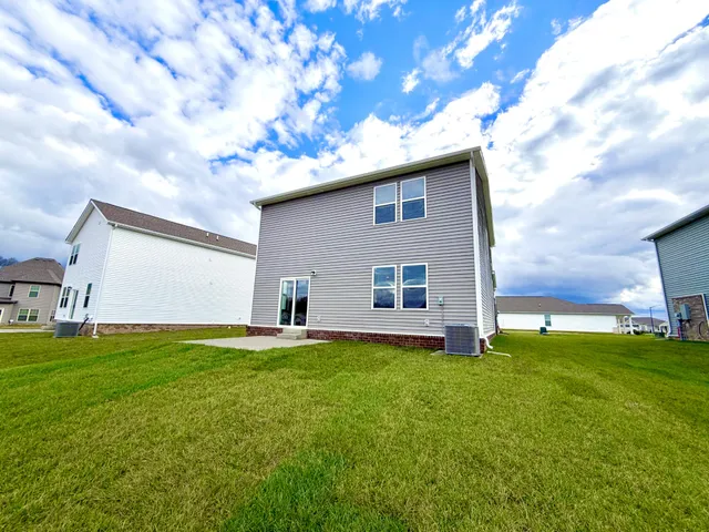 a backyard of a house with table and chairs