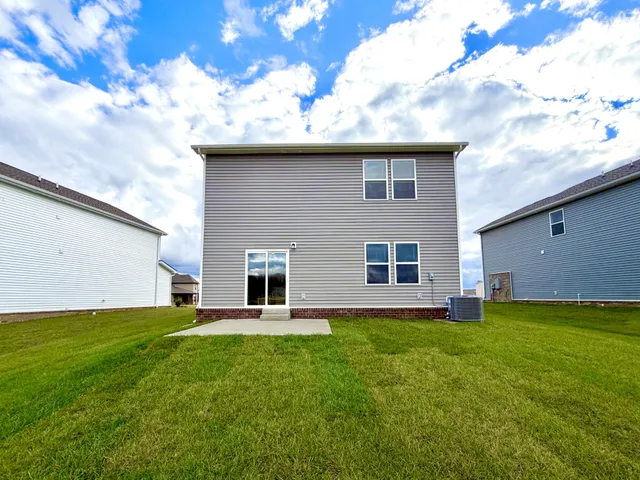 a house view with a sitting space and garden