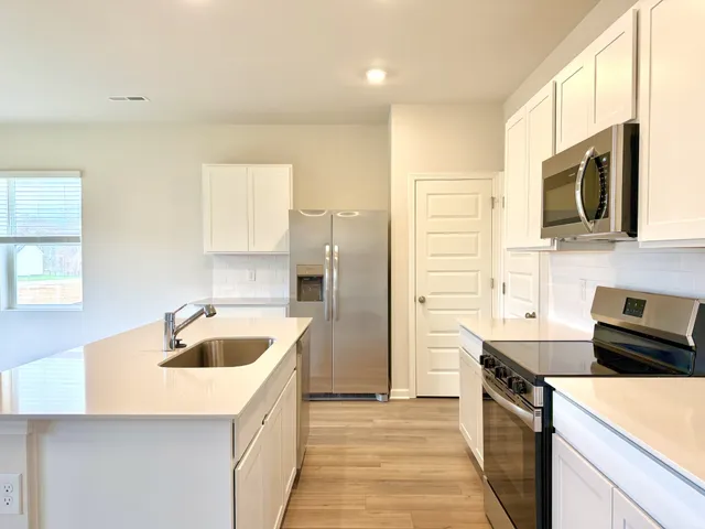 a kitchen with a sink a stove and refrigerator