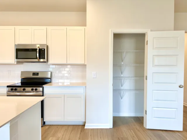 a kitchen with a refrigerator stove and microwave