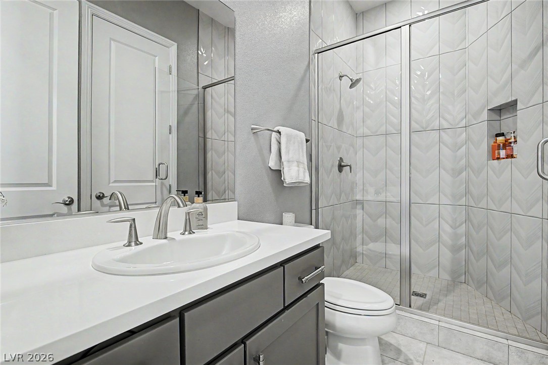 6014 Willow Ridge Court Las Vegas, NV 89135 - Photo 54 of 99 This sleek bathroom features a modern vanity and a spacious, tiled walk-in shower.