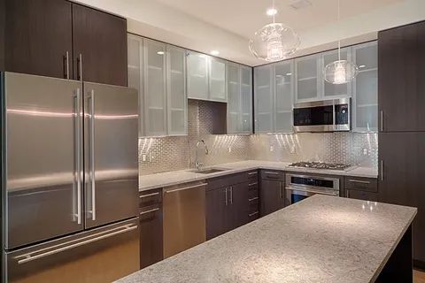 a kitchen with a refrigerator and a sink