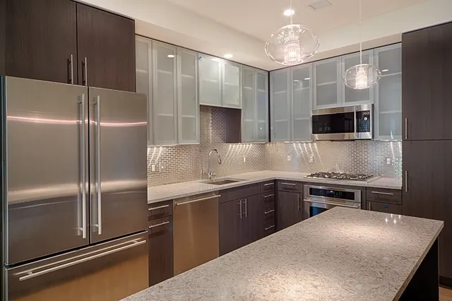 a kitchen with a refrigerator and a sink