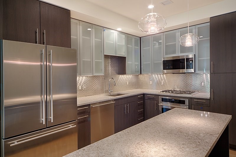 1 Canal Street, Unit 1105 Boston, MA 02114 - Photo 2 of 12 a kitchen with a refrigerator and a sink