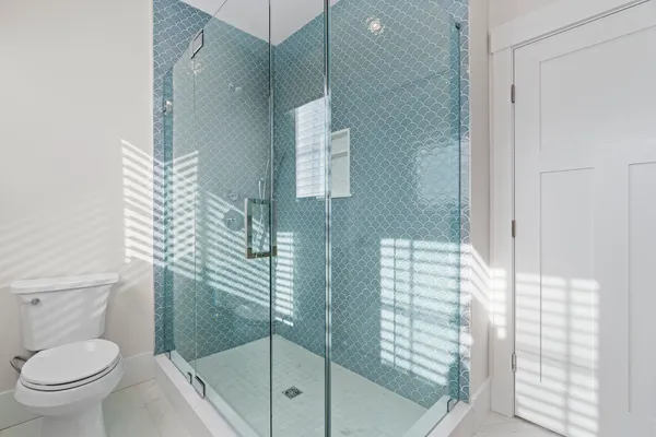 a bathroom with a toilet and a shower