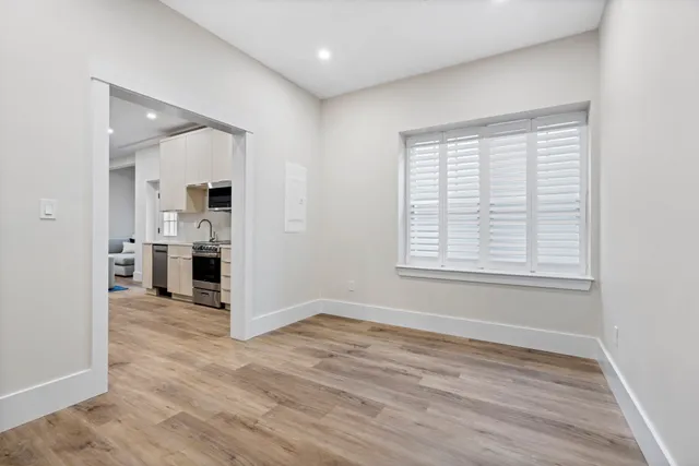 a view of a kitchen with wooden floor and a kitchen