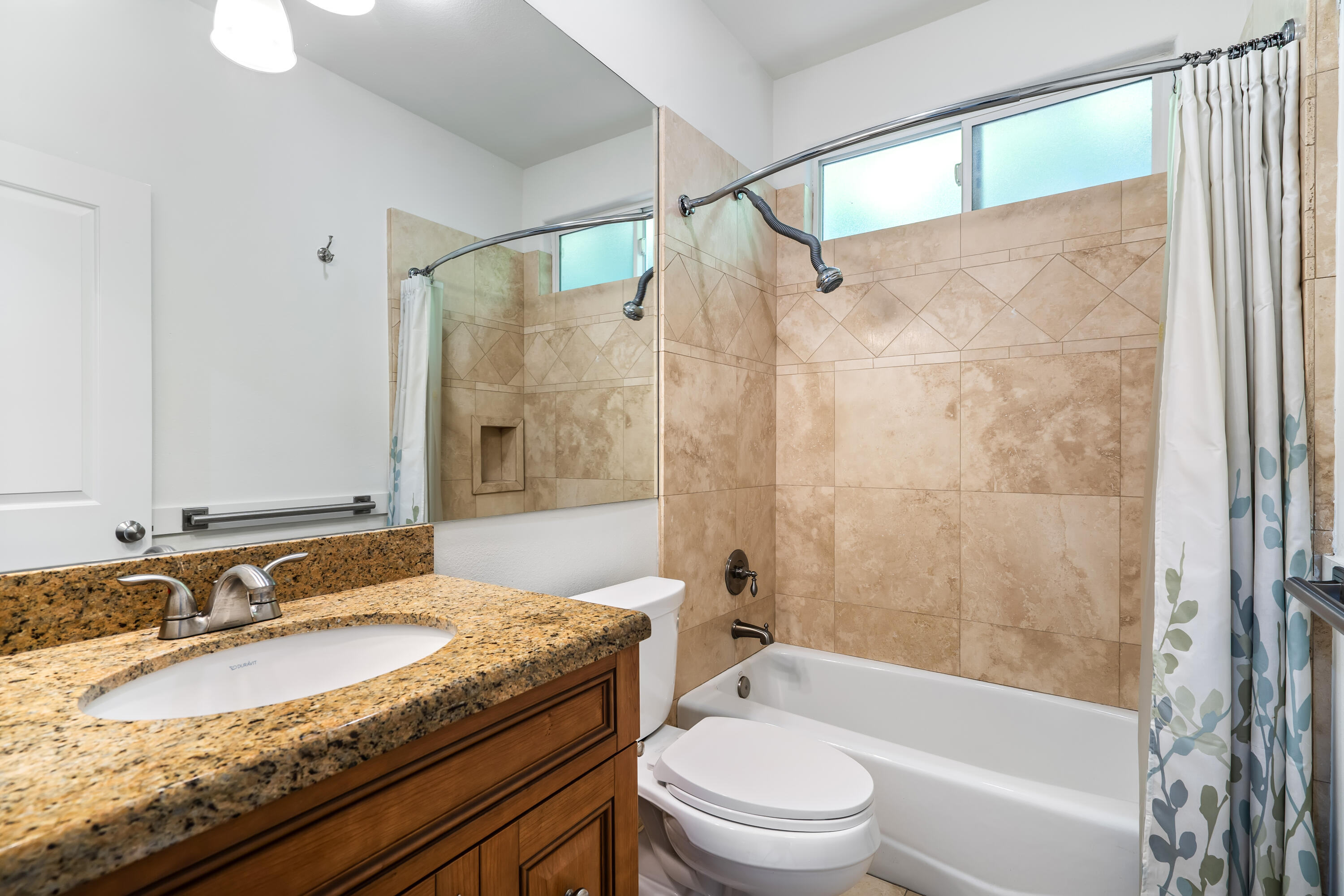 9580 Congressional Road Desert Hot Springs, CA 92240 - Photo 26 of 61 a bathroom with a granite countertop sink toilet and shower