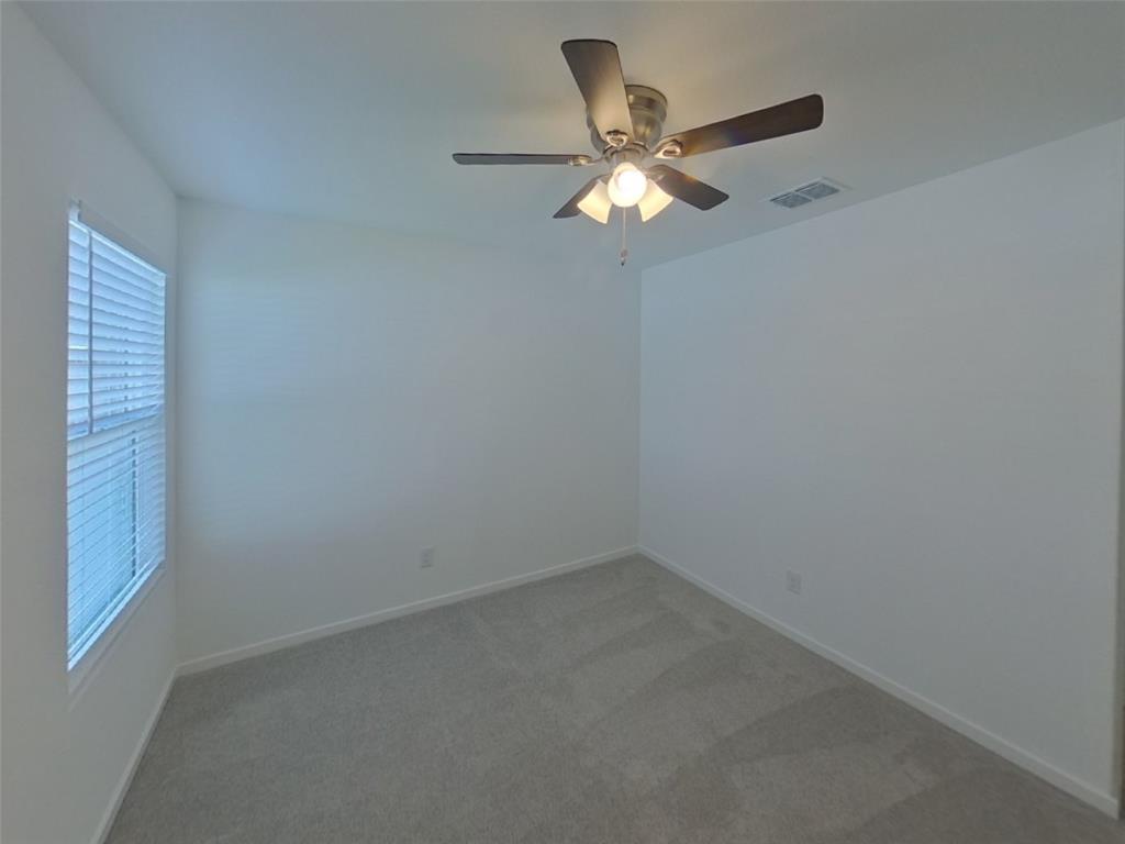 1613 Parlier Street McKinney, TX 75071 - Photo 12 of 22 an empty room with a window and a fan