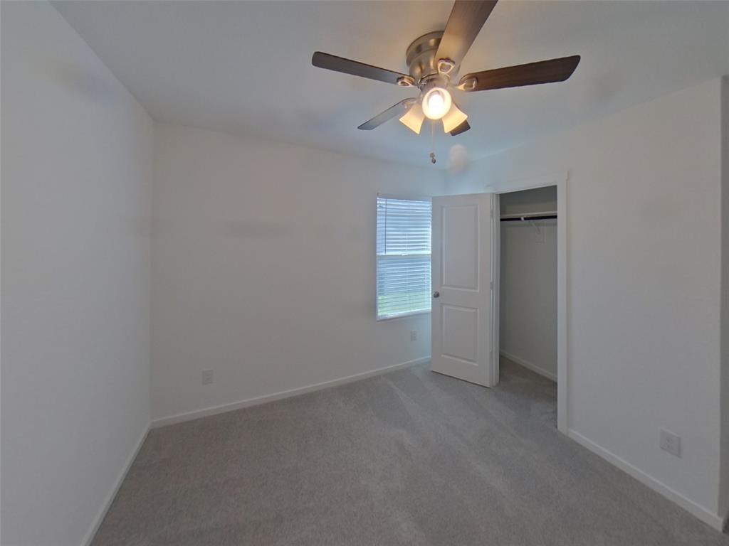 1613 Parlier Street McKinney, TX 75071 - Photo 15 of 22 an empty room with a chandelier fan and windows