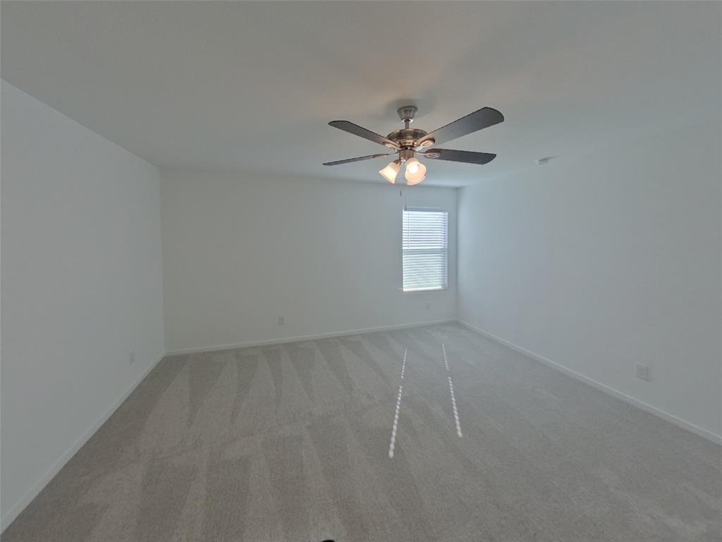 1613 Parlier Street McKinney, TX 75071 - Photo 2 of 22 an empty room with windows and fan
