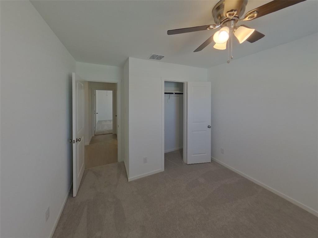 1613 Parlier Street McKinney, TX 75071 - Photo 9 of 22 en empty room with closet and a chandelier fan