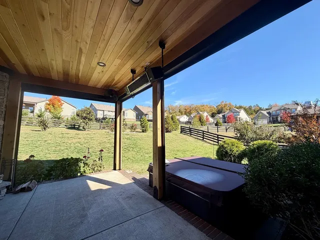 a view of a porch with furniture and garden