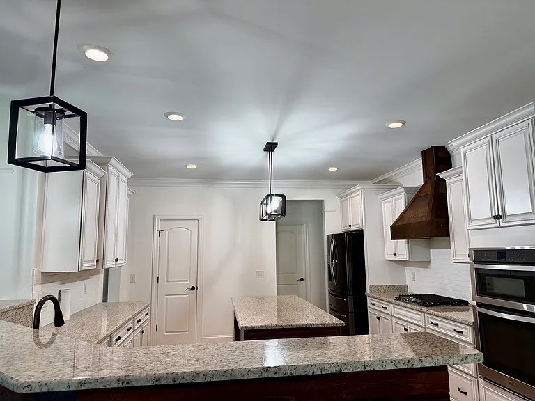 6664 Edgemoore Drive College Grove, TN 37046 - Photo 5 of 25 a kitchen with stainless steel appliances kitchen island granite countertop a sink and a stove top oven with granite countertops