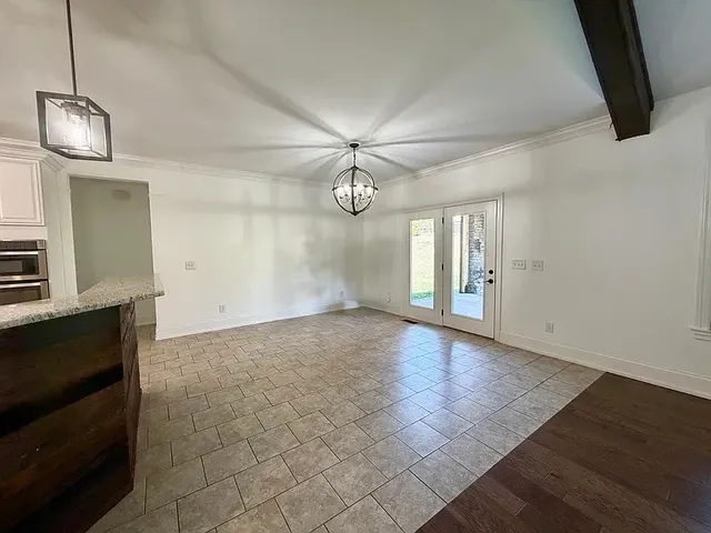 a view of an empty room with a fireplace and a window