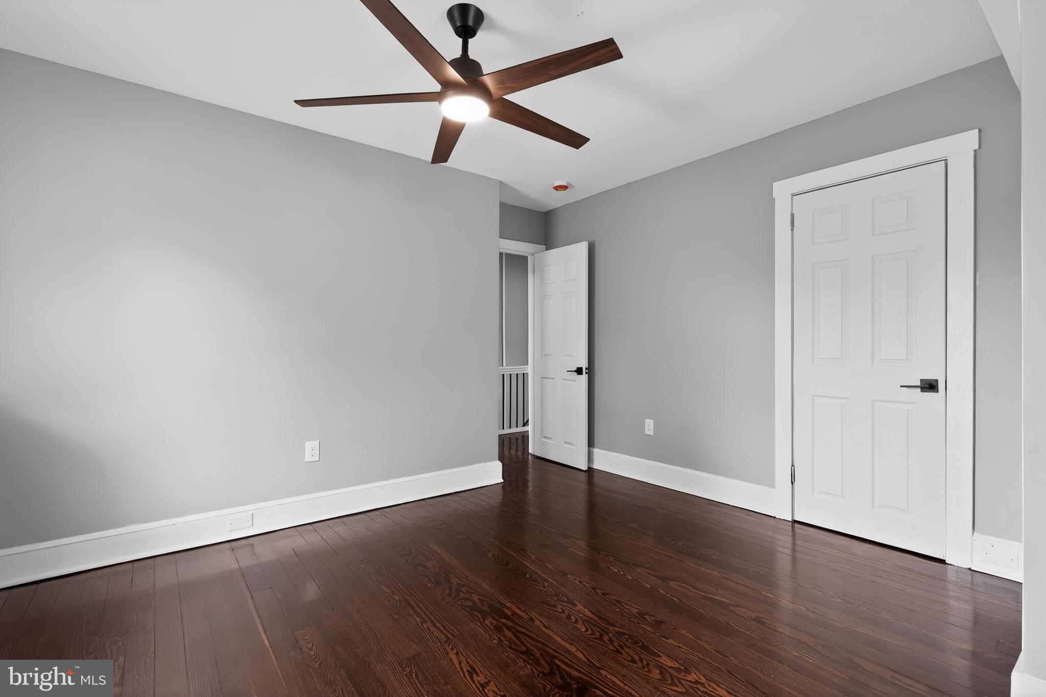 223 Noreg Place Brooklawn, NJ 08030 - Photo 26 of 36 an empty room with wooden floor and windows