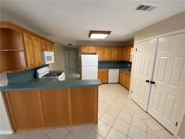 a kitchen with stainless steel appliances granite countertop a sink and cabinets