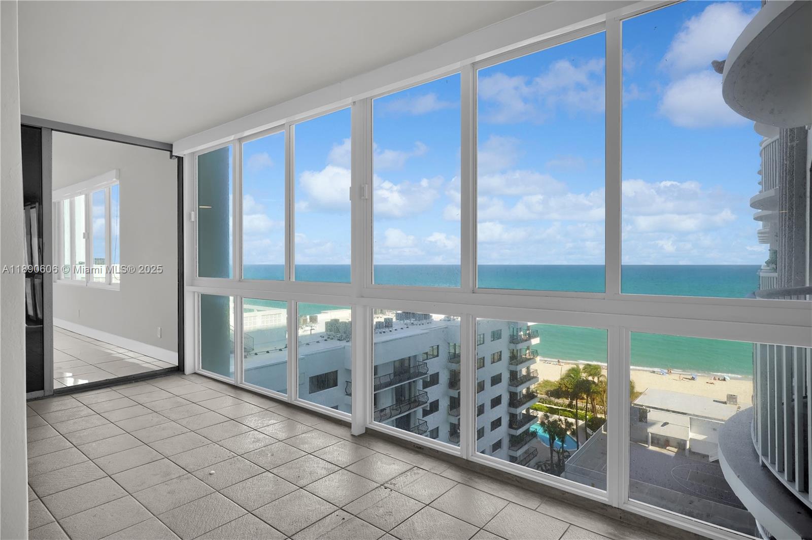 5401 Collins Avenue, Unit 819 Miami Beach, FL 33140 - Photo 18 of 40 a view of a glass door with furniture and floor to ceiling window