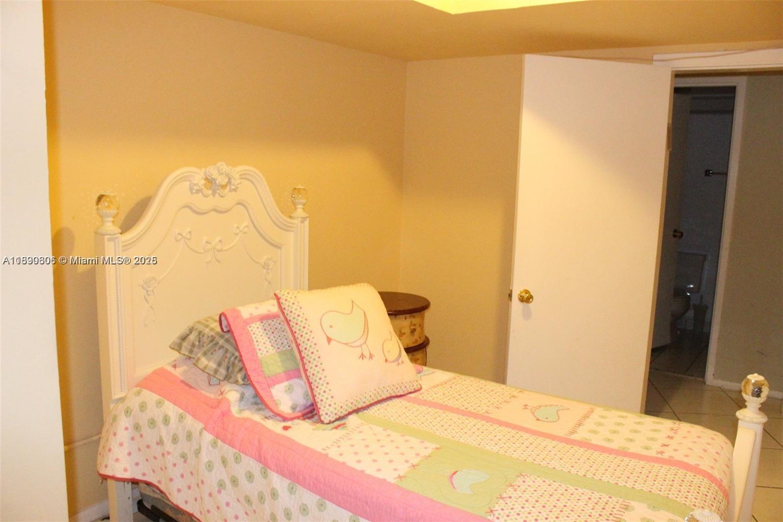 5401 Collins Avenue, Unit 819 Miami Beach, FL 33140 - Photo 29 of 40 a bedroom with a bed and a night stand