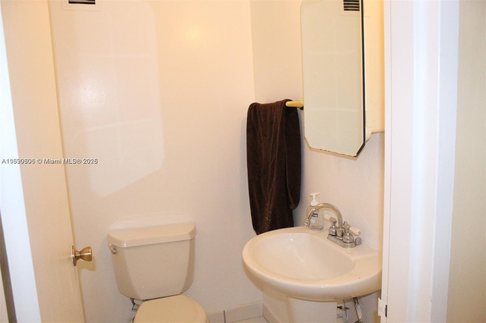 5401 Collins Avenue, Unit 819 Miami Beach, FL 33140 - Photo 32 of 40 a bathroom with a toilet and a sink