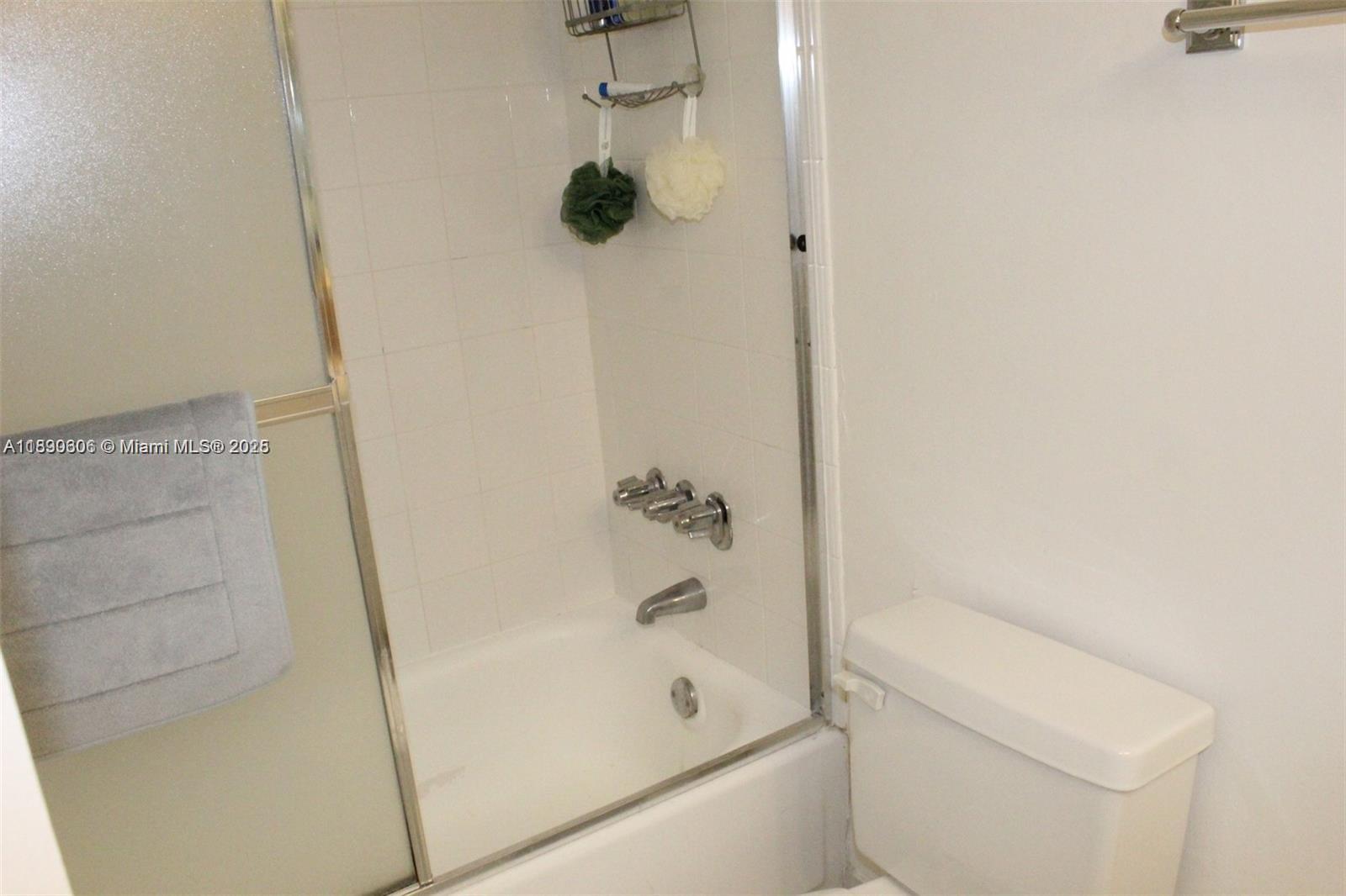 5401 Collins Avenue, Unit 819 Miami Beach, FL 33140 - Photo 34 of 40 a bathroom with a bathtub and a shower