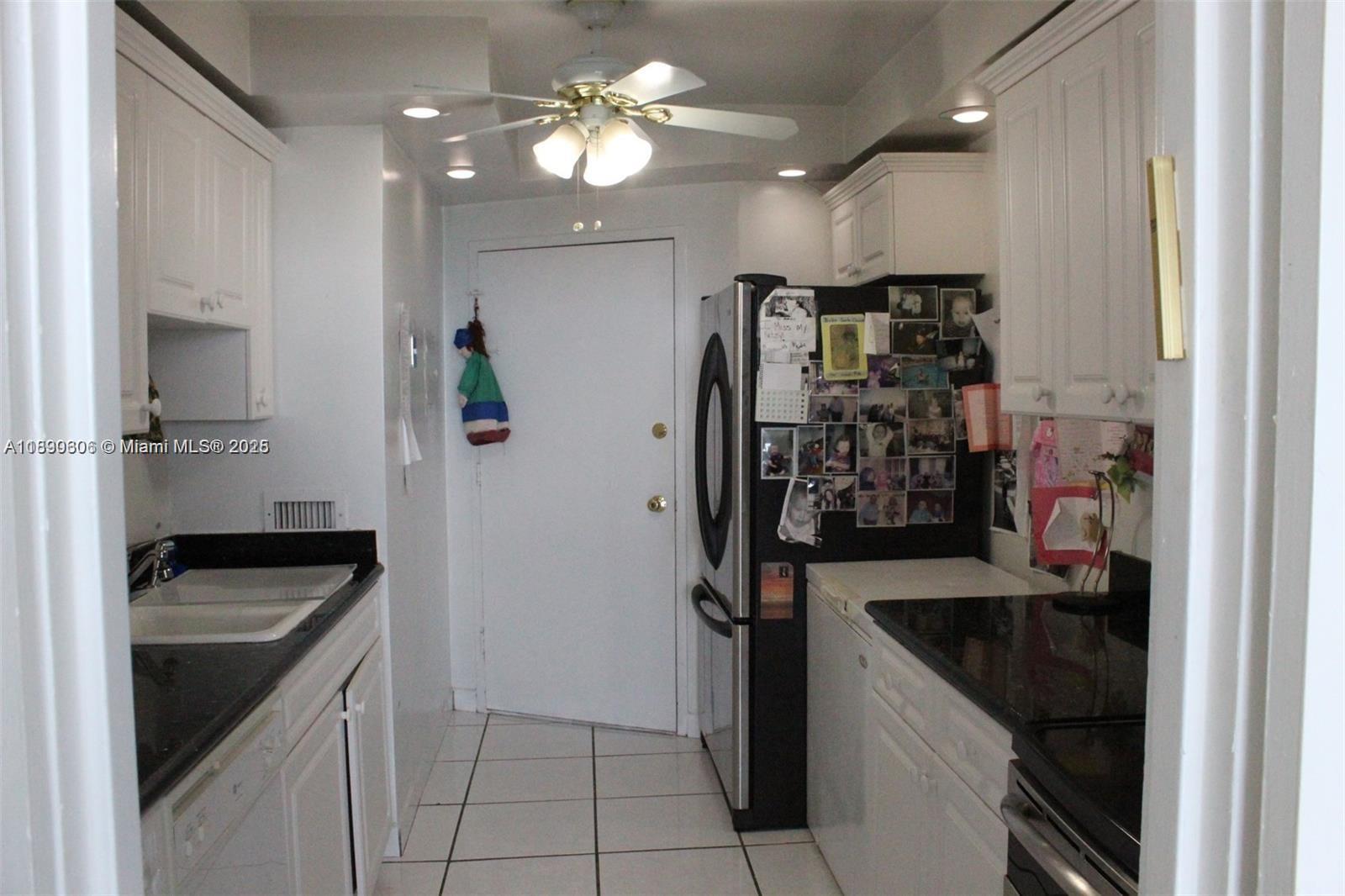5401 Collins Avenue, Unit 819 Miami Beach, FL 33140 - Photo 35 of 40 a kitchen with stainless steel appliances granite countertop a sink a refrigerator and a stove top oven