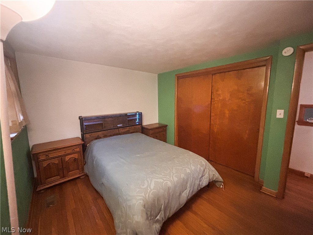 724 East Main Street Barnesville, OH 43713 - Photo 20 of 28 Bedroom with dark wood-style flooring and a closet