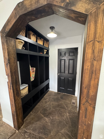 1237 South 260 West Payson, UT 84651 - Photo 37 of 81 Wood-finish arched entryway framing a mudroom with built-in black shelving