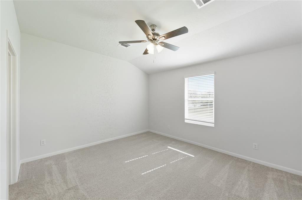 404 Jameson Springtown, TX 76082 - Photo 12 of 16 an empty room with window and ceiling fan