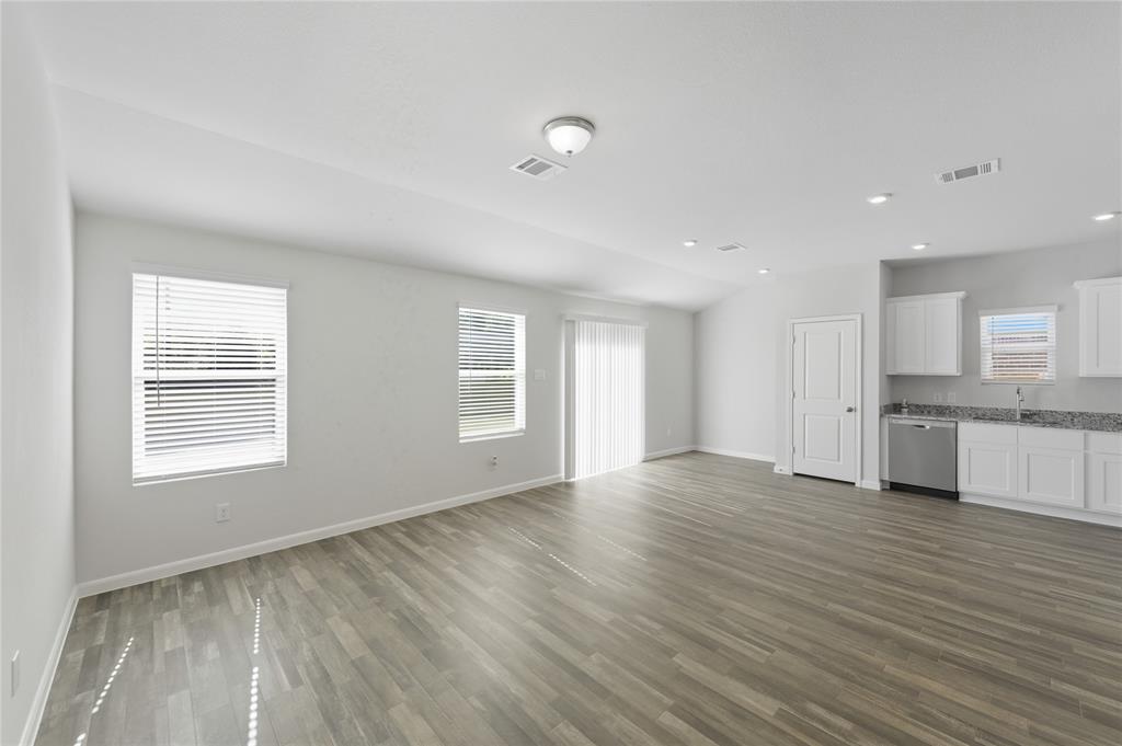 404 Jameson Springtown, TX 76082 - Photo 2 of 16 a view of an empty room with wooden floor and a window