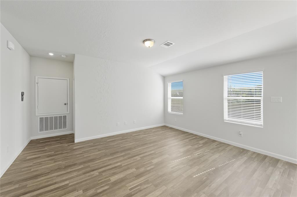 404 Jameson Springtown, TX 76082 - Photo 3 of 16 a view of an empty room with wooden floor and a window