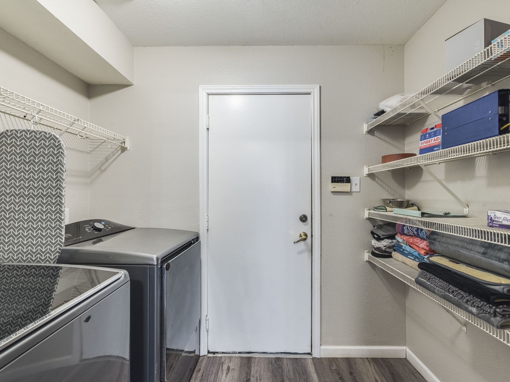 1415 Roxanne's Run Pflugerville, TX 78660 - Photo 6 of 30 Functional laundry space offering ample storage with convenient wire shelving.